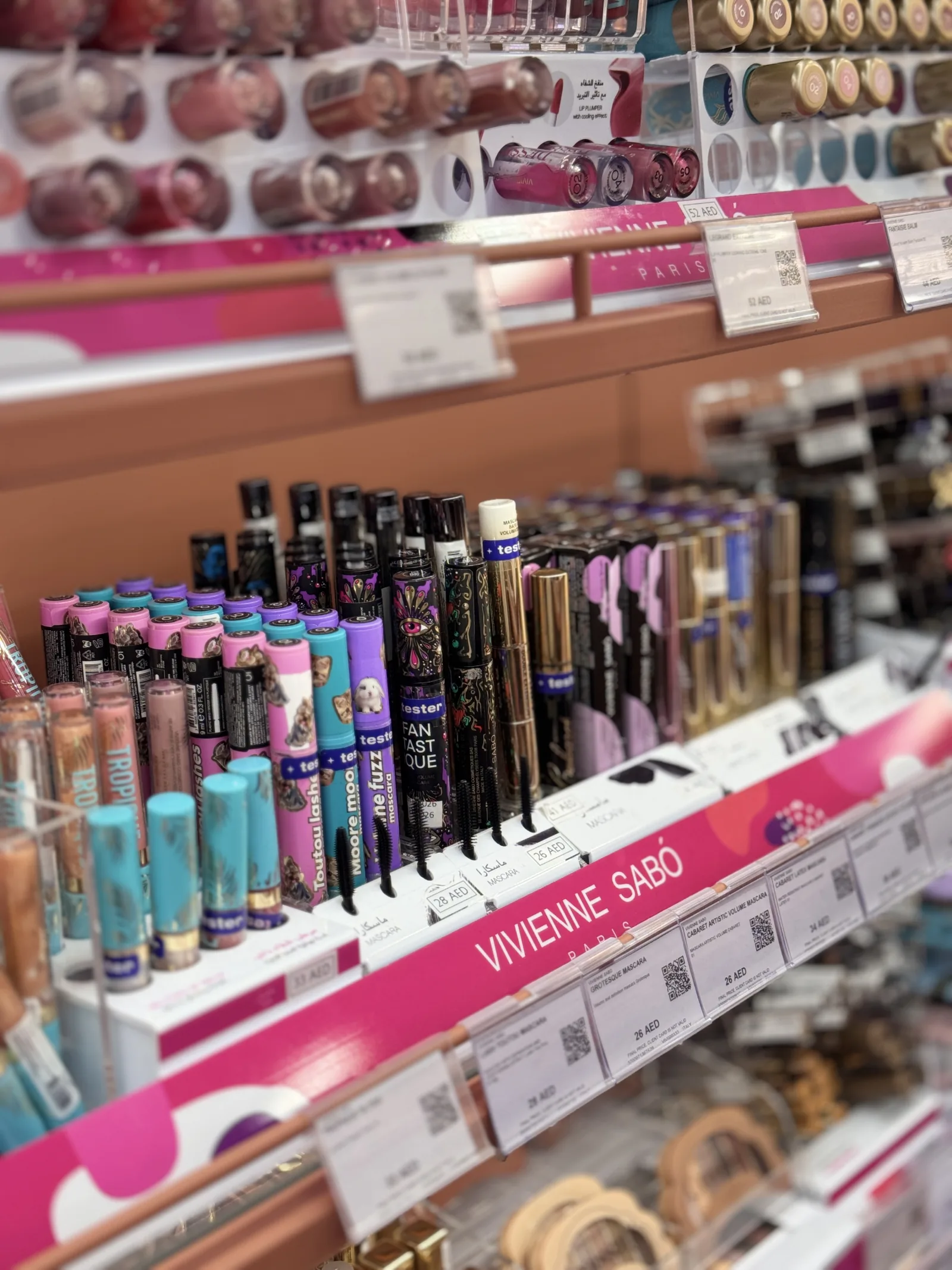 The Vivienne Sabo shelf strip — mascaras, liners and lip products lined up on the branded fixture.