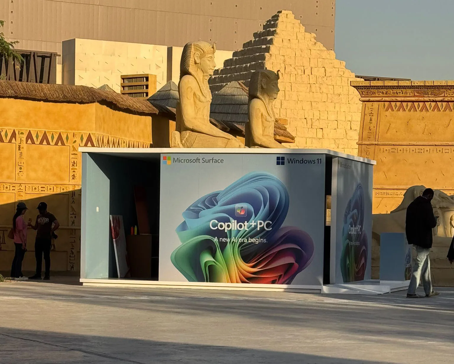 The Microsoft Copilot+ PC pop-up pavilion at BLVD, Riyadh, set against the venue’s Egyptian-themed pharaoh statues and stonework.