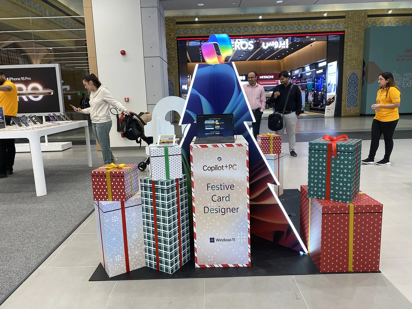 Copilot+PC ‘Festive Card Designer’ gift-tree activation in a UAE mall, surrounded by wrapped gift boxes