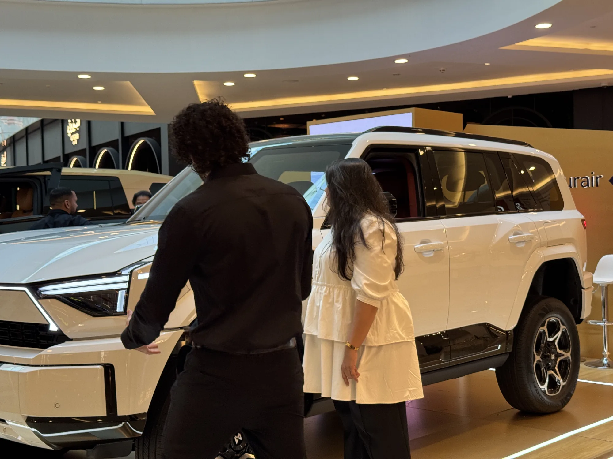 An ambassador showing the white MHERO II to a visitor.