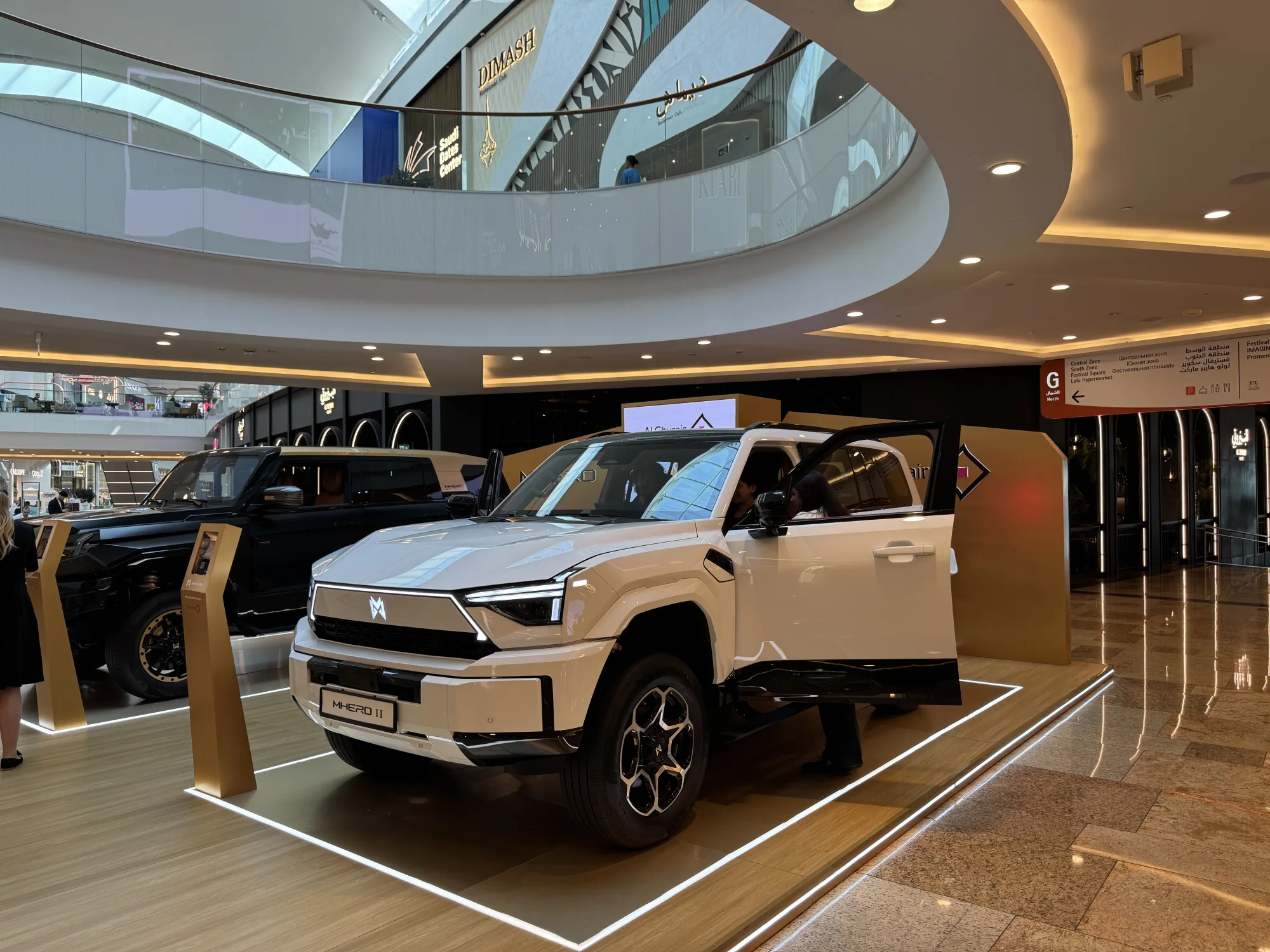 A visitor and ambassador at the open door of the white MHERO II.